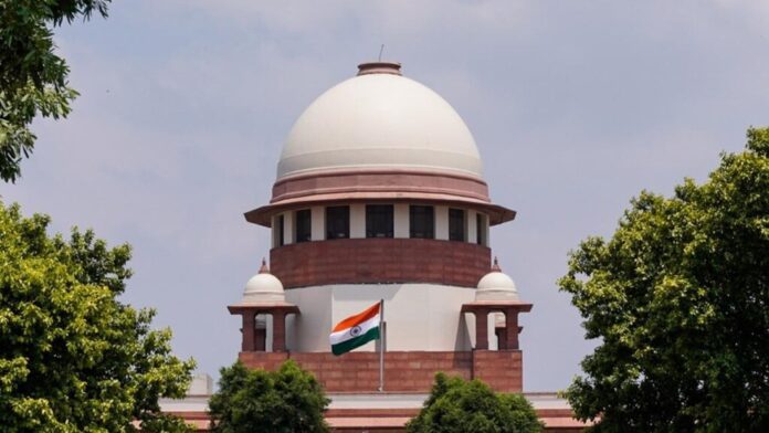 Supreme Court of India building with a banner on NEET protests
